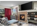 Comfortable living room featuring a fireplace, flat screen tv, and stylish decor at 15800 E 121St Ave # 4K, Brighton, CO 80603