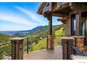 Covered porch with stone pillars offers panoramic views of the mountains and valley at 166 Valley View Way, Boulder, CO 80304