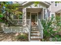 Inviting front porch with a decorative wreath on the front door, showcasing a charming outdoor space at 1675 Saratoga Dr, Lafayette, CO 80026