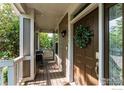 Cozy front porch with string lights, a bistro set, and a green wreath, creating an inviting outdoor entrance at 1675 Saratoga Dr, Lafayette, CO 80026