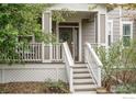 Welcoming front porch with entry door and stairs leading up to the home at 1675 Saratoga Dr, Lafayette, CO 80026
