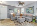 Cozy living room with a large sectional sofa, hardwood floors, and ample natural light at 1675 Saratoga Dr, Lafayette, CO 80026