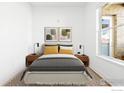 Comfortable bedroom with neutral tones, stylish decor, and large window for natural light at 1707 Walnut St # 101, Boulder, CO 80302