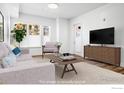Cozy living room featuring modern furniture, a soft rug, and a sleek entertainment center at 1707 Walnut St # 101, Boulder, CO 80302