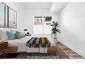 Light and bright bedroom with a large window, neutral walls, and modern decor at 1707 Walnut St # 102, Boulder, CO 80302