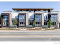 Modern condo building exterior featuring mixed facade of stone, wood, and balconies on a sunny day at 1707 Walnut St # 104, Boulder, CO 80302