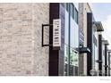 Exterior side view of condo building at 17*Walnut featuring stone and modern wood siding at 1707 Walnut St # 104, Boulder, CO 80302