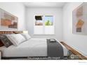 Cozy bedroom featuring plush bedding, decorative pillows, and soft natural light from the window at 1707 Walnut St # 106, Boulder, CO 80302