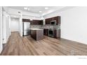 Modern kitchen boasts stainless steel appliances, dark cabinetry, and a functional center island at 1707 Walnut St # 106, Boulder, CO 80302