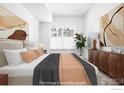 Serene bedroom with a neutral color palette, large windows, and stylish furnishings at 1707 Walnut St # 203, Boulder, CO 80302