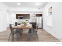 Dining area connected to the kitchen, featuring a wooden table with seating and modern finishes at 1707 Walnut St # 207, Boulder, CO 80302
