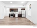Modern kitchen with stainless steel appliances, dark wood cabinets, and sleek countertops at 1707 Walnut St # 207, Boulder, CO 80302