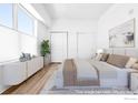 Spacious primary bedroom offering ample natural light, contemporary furniture, and walk-in closet access at 1707 Walnut St # 210, Boulder, CO 80302