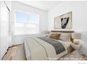 Cozy bedroom with neutral tones, a large window, and stylish accents, creating a serene retreat at 1707 Walnut St # 210, Boulder, CO 80302