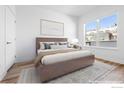 Bright bedroom boasts a large window, plush carpeting, and neutral decor, creating a serene atmosphere at 1707 Walnut St # 301, Boulder, CO 80302