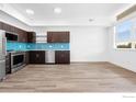 Modern kitchen featuring sleek dark cabinets, stainless steel appliances, and a vibrant blue tile backsplash at 1707 Walnut St # 305, Boulder, CO 80302