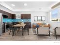 Open living space featuring a kitchen with blue backsplash and a comfortable seating area with modern decor at 1707 Walnut St # 305, Boulder, CO 80302