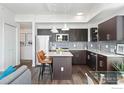 Modern kitchen with an island, pendant lighting, stainless steel appliances, and bar stool seating at 1707 Walnut St # 306, Boulder, CO 80302