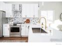 Stylish kitchen with stainless steel appliances, white countertops, and modern fixtures at 1920 Donovan Dr, Longmont, CO 80501