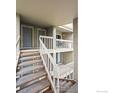 Staircase leading to upper level condos; each with gray doors and white banisters at 20 S Boulder Cir # 2312, Boulder, CO 80303