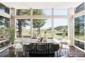 Bright dining room features large windows with scenic views and a stylish wood table with seating for eight at 2848 S Lakeridge Trl, Boulder, CO 80302