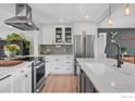 Modern kitchen featuring stainless steel appliances, a tiled backsplash, and white cabinetry at 301 29Th St, Boulder, CO 80305