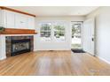Cozy living room with a fireplace, hardwood floors, and natural light from windows at 3098 W 107Th Pl # C, Westminster, CO 80031