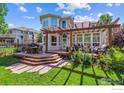 Charming backyard featuring a spacious deck, pergola, and outdoor dining area at 4059 Nevis St, Boulder, CO 80301
