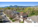 A beautiful home with a scenic mountain view in the background and mature trees surrounding the neighborhood at 4059 Nevis St, Boulder, CO 80301