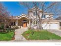 Charming front exterior of a two-story home featuring a brick facade and a well-manicured lawn at 4059 Nevis St, Boulder, CO 80301