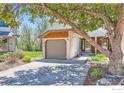 Charming home featuring an attached garage, front yard landscaping, and mature tree at 4619 Chestnut Ln, Boulder, CO 80301