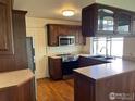 Well-equipped kitchen featuring dark wood cabinets, sleek appliances, and ample counter space at 4619 Chestnut Ln, Boulder, CO 80301