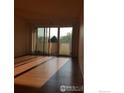 Living room with hardwood floors and sliding glass doors to the balcony at 5124 Williams Fork Trl # 204, Boulder, CO 80301