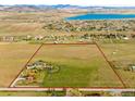 Large lot aerial view highlighting the property's boundaries and proximity to nearby lake at 6310 W County Road 4, Berthoud, CO 80513