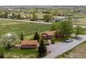 Charming home with a well-maintained yard, mature trees, and a gravel driveway at 6310 W County Road 4, Berthoud, CO 80513