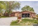 Welcome to this cozy home featuring a gravel driveway, garage, and inviting outdoor space at 6310 W County Road 4, Berthoud, CO 80513