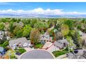 Aerial view of home in a lush neighborhood surrounded by mature trees and well-maintained landscaping at 7905 Wellshire Ct, Niwot, CO 80503