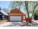 Charming two-story home with an attached two-car garage and neatly maintained landscaping and a fire hydrant at 1072 Townley Cir, Longmont, CO 80501