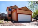 Well-maintained home with a two-car garage and clean landscaping, showcasing a comfortable suburban living space at 1072 Townley Cir, Longmont, CO 80501