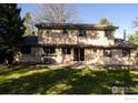 Expansive backyard with a large grassy area and a concrete patio, ideal for outdoor entertaining at 11845 W 73Rd Dr, Arvada, CO 80005