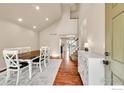 Bright dining room featuring wood floors, a large table, and staircase at 1204 Ptarmigan Dr, Longmont, CO 80504
