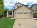 Charming home with a two-car garage, covered porch, and manicured lawn at 1204 Ptarmigan Dr, Longmont, CO 80504