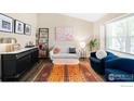 Bright living room with hardwood floors, a comfy sofa, stylish rug, and an accent chair at 12506 Maria Cir, Broomfield, CO 80020