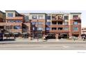 Exterior view of the brick apartment complex featuring balconies and an entrance at 1301 Canyon Blvd # 207, Boulder, CO 80302