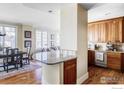 Partial view of the kitchen and dining area with an open floor plan and wooden cabinets at 1301 Canyon Blvd # 207, Boulder, CO 80302