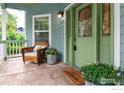 Inviting front porch with a wicker chair, potted plants, and a decorative welcome mat at 1369 Padfield Pl, Erie, CO 80516