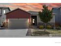 Well-maintained home featuring a two-car garage, mature landscaping, and a cozy front porch at 14868 Guernsey Dr, Mead, CO 80542