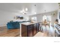 Granite kitchen island overlooks the Gathering room and adjacent dining area at 14868 Guernsey Dr, Mead, CO 80542