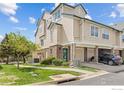 Inviting multi-level townhouse with attached garages and a well-manicured lawn under a bright blue sky at 1866 Mallard Dr, Superior, CO 80027
