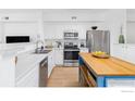 Bright kitchen with stainless steel appliances, custom island, and ample counter space, perfect for cooking at 1866 Mallard Dr, Superior, CO 80027